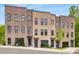 Attractive townhome showcasing a brick facade with modern windows and inviting entrances on a well-maintained street at 923 Echo Park Dr, Suwanee, GA 30024