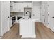 Contemporary kitchen with white cabinets, stainless steel appliances, and wood flooring at 923 Echo Park Dr, Suwanee, GA 30024