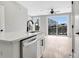 Modern kitchen with an island, stainless steel dishwasher, and light hardwood flooring at 923 Echo Park Dr, Suwanee, GA 30024