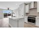 Eat-in Kitchen island features white cabinetry, an undermount sink and stainless appliances at 923 Echo Park Dr, Suwanee, GA 30024