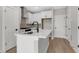 Modern kitchen featuring an island, sleek black hardware, stainless steel appliances and open layout at 923 Echo Park Dr, Suwanee, GA 30024