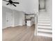 Inviting open-concept living area with hardwood floors flowing into a modern kitchen and staircase at 923 Echo Park Dr, Suwanee, GA 30024