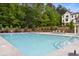 Community pool with lounge chairs and well-maintained landscaping at 923 Echo Park Dr, Suwanee, GA 30024
