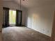 Bedroom with vaulted ceiling, neutral carpet, large window and decorative curtains at 7472 Wood Ct, Lithonia, GA 30058