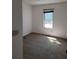 A bright bedroom with a window, neutral carpet and a ceiling light at 7472 Wood Ct, Lithonia, GA 30058
