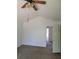 Bright bedroom with vaulted ceiling, fan, neutral carpet, and an adjacent doorway at 7472 Wood Ct, Lithonia, GA 30058
