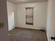 Cozy bedroom with window, neutral carpet, and minimalist decor, offering a comfortable and private space at 7472 Wood Ct, Lithonia, GA 30058
