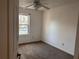 A bright bedroom with a window, neutral carpet and view of the neighborhood at 7472 Wood Ct, Lithonia, GA 30058