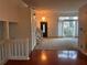 Inviting entryway with hardwood floors, carpet, and a modern chandelier fixture at 7472 Wood Ct, Lithonia, GA 30058