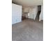 Spacious living room with carpet, staircase, and bright light at 7472 Wood Ct, Lithonia, GA 30058