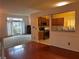 Open-concept living room leading to a kitchen area with hardwood floors and neutral paint at 7472 Wood Ct, Lithonia, GA 30058