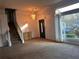 Welcoming living room with staircase, chandelier, and a view of the outdoors at 7472 Wood Ct, Lithonia, GA 30058