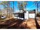 View of backyard, showcasing screened porch and shed at 204 Apple Branch Dr, Woodstock, GA 30188