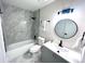 Modern bathroom with gray marble tile and a bathtub at 204 Apple Branch Dr, Woodstock, GA 30188