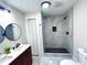 Modern bathroom with double vanity, walk-in shower, and herringbone tile floor at 204 Apple Branch Dr, Woodstock, GA 30188