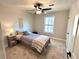 Cozy bedroom featuring a twin bed, ceiling fan, and window at 204 Apple Branch Dr, Woodstock, GA 30188