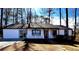 Newly renovated house exterior boasts white siding, dark trim, and a welcoming front porch at 204 Apple Branch Dr, Woodstock, GA 30188