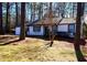 Charming one-story home features white exterior, landscaping, and a tree-lined setting at 204 Apple Branch Dr, Woodstock, GA 30188