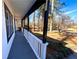 Inviting front porch with white railings and a view of the wooded yard at 204 Apple Branch Dr, Woodstock, GA 30188