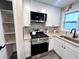 Modern kitchen with white shaker cabinets, granite countertops, and stainless steel appliances at 204 Apple Branch Dr, Woodstock, GA 30188