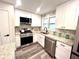 Modern kitchen with white shaker cabinets, granite countertops, and stainless steel appliances at 204 Apple Branch Dr, Woodstock, GA 30188