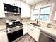 Modern kitchen with white shaker cabinets, granite countertops, and stainless steel appliances at 204 Apple Branch Dr, Woodstock, GA 30188