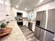 Modern kitchen with white shaker cabinets, granite countertops, and stainless steel appliances at 204 Apple Branch Dr, Woodstock, GA 30188