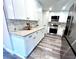 Modern kitchen with white shaker cabinets, granite countertops, and stainless steel appliances at 204 Apple Branch Dr, Woodstock, GA 30188