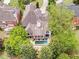 Aerial view of the beautiful home featuring a private backyard with a gorgeous pool and deck area at 220 Windsor Gate Ne Cv, Atlanta, GA 30342