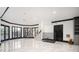 A large basement features marble floors, a Christmas tree, and staircase at 220 Windsor Gate Ne Cv, Atlanta, GA 30342