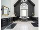 Elegant bathroom with marble floors, a freestanding tub and black accent wall at 220 Windsor Gate Ne Cv, Atlanta, GA 30342