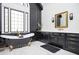 This luxurious bathroom has a freestanding tub and a black accent wall at 220 Windsor Gate Ne Cv, Atlanta, GA 30342