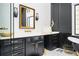 A sleek bathroom features a vanity with gold accents and a glass-enclosed shower at 220 Windsor Gate Ne Cv, Atlanta, GA 30342
