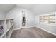 Light and airy bonus room with hardwood flooring, built in shelving, and closet access at 220 Windsor Gate Ne Cv, Atlanta, GA 30342