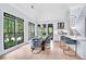 Elegant dining area featuring large windows, modern lighting, and stylish seating at 220 Windsor Gate Ne Cv, Atlanta, GA 30342