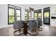 Elegant dining area featuring large windows, modern lighting, and stylish seating at 220 Windsor Gate Ne Cv, Atlanta, GA 30342