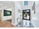 Elegant foyer with gray marble floors, contemporary table, and views into other rooms at 220 Windsor Gate Ne Cv, Atlanta, GA 30342