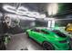 Modern garage with black walls, hexagon lighting, and sleek green car at 220 Windsor Gate Ne Cv, Atlanta, GA 30342