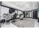 Spacious home office with multiple monitors, desk space, and a ceiling fan at 220 Windsor Gate Ne Cv, Atlanta, GA 30342