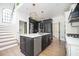 Stunning kitchen featuring a large island with white countertops and modern black cabinetry at 220 Windsor Gate Ne Cv, Atlanta, GA 30342