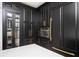 Kitchen with custom black cabinets, gold hardware, and stainless steel appliances at 220 Windsor Gate Ne Cv, Atlanta, GA 30342