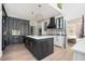 Open concept kitchen with sleek countertops, black cabinets, and modern appliances at 220 Windsor Gate Ne Cv, Atlanta, GA 30342