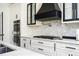 Beautiful kitchen features white marble backsplash, modern appliances, and white cabinets at 220 Windsor Gate Ne Cv, Atlanta, GA 30342