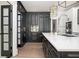 Modern kitchen with a large island, white countertop, stainless steel appliances, and black cabinetry at 220 Windsor Gate Ne Cv, Atlanta, GA 30342