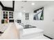 A clean kitchenette features white countertops, cabinets, and a modern cooktop at 220 Windsor Gate Ne Cv, Atlanta, GA 30342