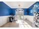 Bright home office with blue accent wall, large window, stylish lighting, and modern decor at 220 Windsor Gate Ne Cv, Atlanta, GA 30342
