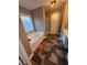 Bright bathroom featuring a soaking tub and modern slate tile flooring at 106 Puckett Ct, Canton, GA 30115