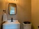 Stylish powder room featuring a modern vanity, black fixtures, and a framed mirror at 106 Puckett Ct, Canton, GA 30115