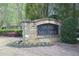 Elegant stone entrance sign for The Falls at Mill Creek community at 106 Puckett Ct, Canton, GA 30115