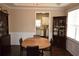 Charming dining room with dark wood furniture, hardwood floors, and an open view to the kitchen at 106 Puckett Ct, Canton, GA 30115